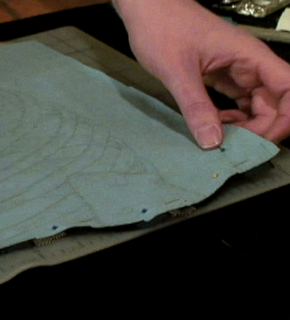 A person placing two pieces of fabric together.