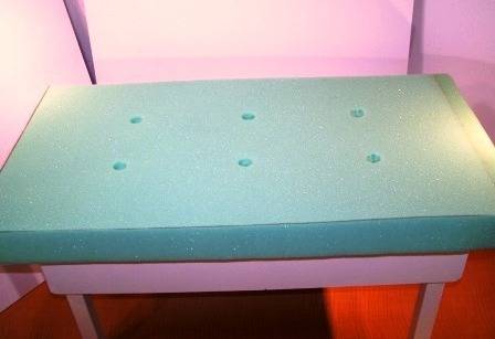Sponge cushion is attached to a bench.