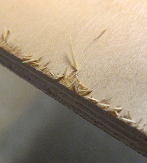 Shreds of something peeling from the edge of an object.