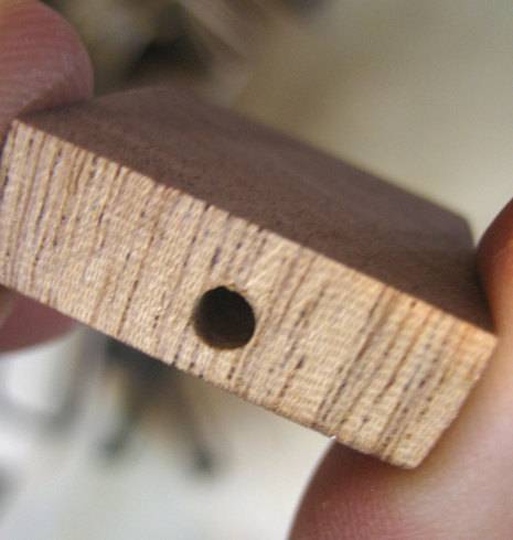 A wooden piece with the hole used for book mark.