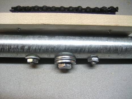 Fasteners are seen on a metal rod.