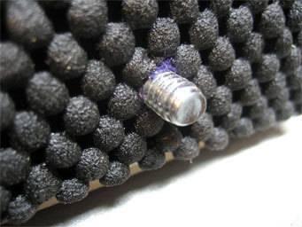 Insert the screw through the felt back.