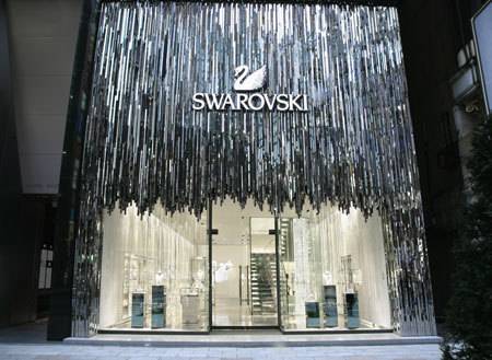 A building has the word Swarovski and a swan on the front.