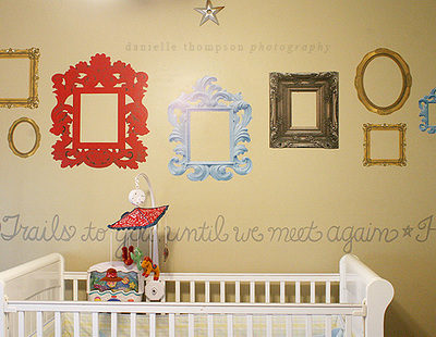 Vinyl photo frames wall decal at the side of the baby bed cot.