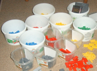 White cups are filled with colorful items.