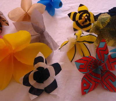 Colorful flower decorations sit on a white surface.