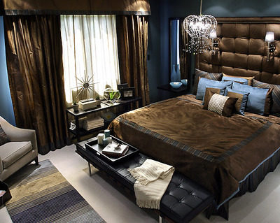 Chocolate color bedroom with bed, couch, chair, bed lights, and shandler.