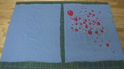 Red balloons are printed on a light blue material.