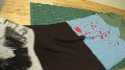 Red balloons are shown on a multicolored piece of material.