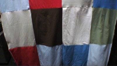 Rectangular patches of various solid colors sewn together like a quilt.