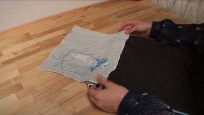 A person working with a white material on the floor.