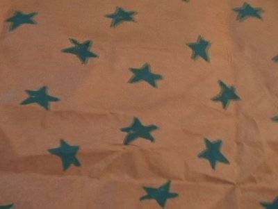 Blue stars on top of a white piece of wrapping paper.