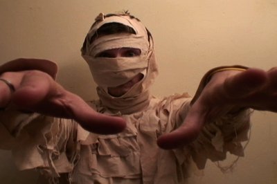 Man dressed in a mummy costume.