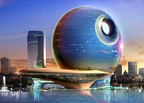Waterfront hotel with a huge round shape that is covered with glass.