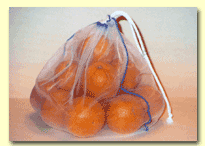 A clear bag holds several orange fruits.