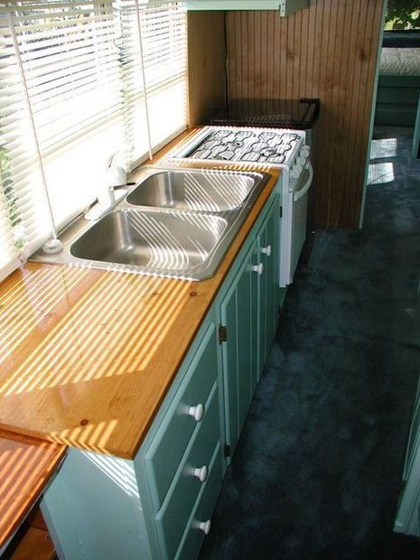 A wooden countertop with metal sink.