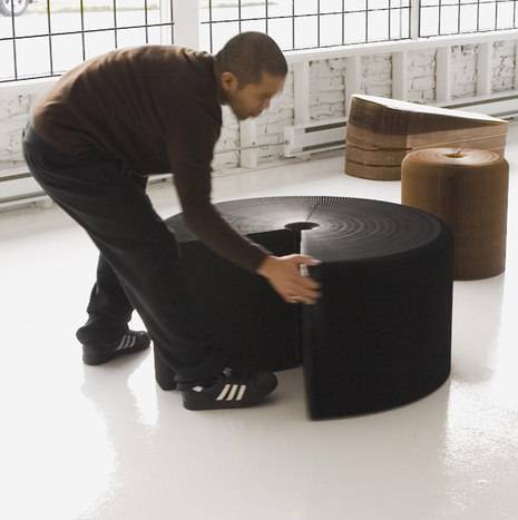 A man moving a small black table.