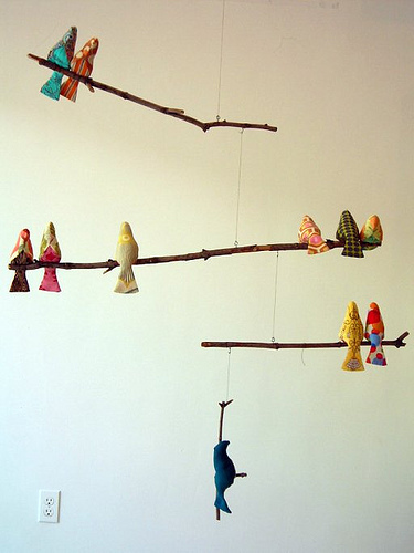FEW HANDMADE FABRIC BIRDS IN WALL.