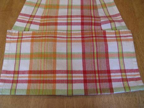 A traditional style napkin in white red and yellow