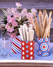 Several colorful cups with flowers and sticks