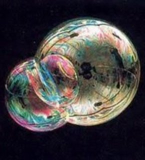 A bright pink bubble with many colors and smaller bubbles attached.