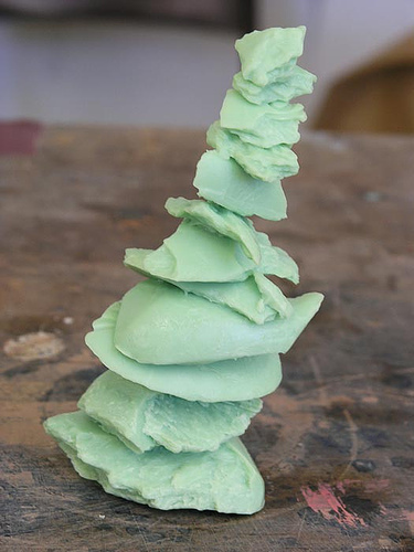 A tower of soap bars, made in an emerald green color.