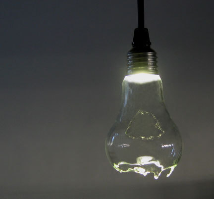 A broken lit light bulb hangs from a ceiling.