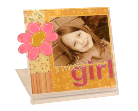 A picture frame with a pink flower and the words "sweet girl" encloses a picture of a young girl smiling.