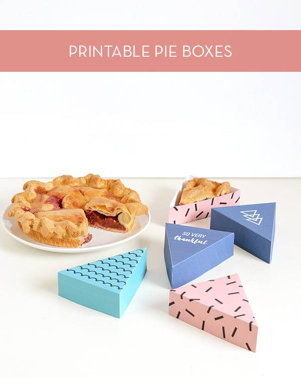Homemade boxes for carrying single slices of pie sit on a table.