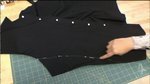 A hand working on black fabric.