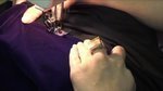 A person stitching the clothe in the sewing machine