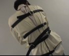 A man is tied in a straight jacket.