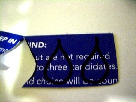 A blue tag or card that has been ripped in half.