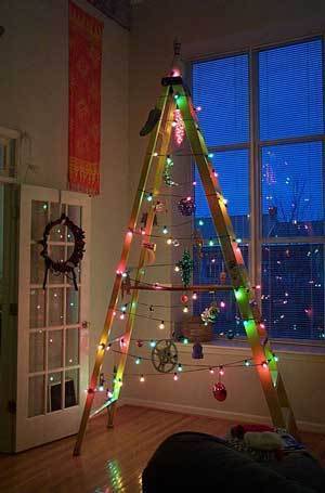 A seven foot tall tripod is strung with Christmas lights to create a makeshift Christmas tree.