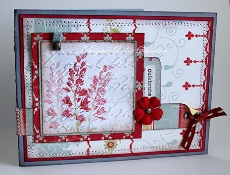 A white case decorated with red flowers sits on a white table.