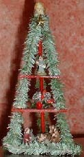 A Christmas tree with decorating dolls