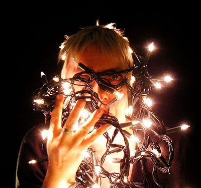 A woman is holding vines that light up.
