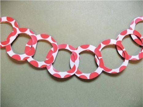 A paper design of pink hoops hanging on the wall.