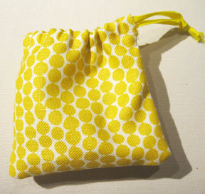 A yellow and white polka dot coin bag.