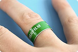 A finger with a green bandage.