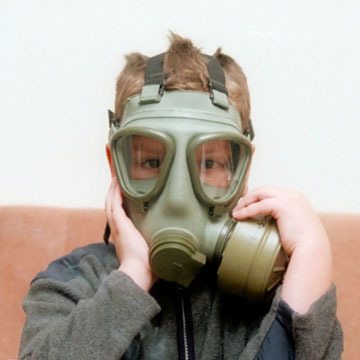 A person with a green gas mask on.