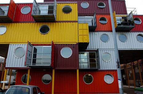 A colorful apartment building made of many shipping containers.