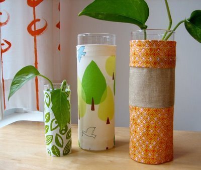 Glass tubes with plants are decorated with colorful papers.