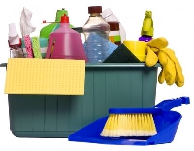 Cleaning tray holding cleaning supplies such as bottles, gloves, and cloths.