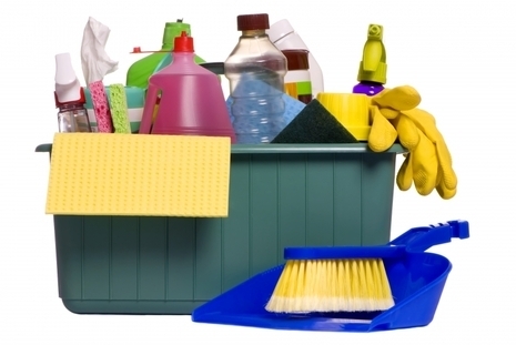 Cleaning tray holding cleaning supplies such as bottles, gloves, and cloths.