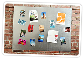 A magnetic photo board on a brick wall
