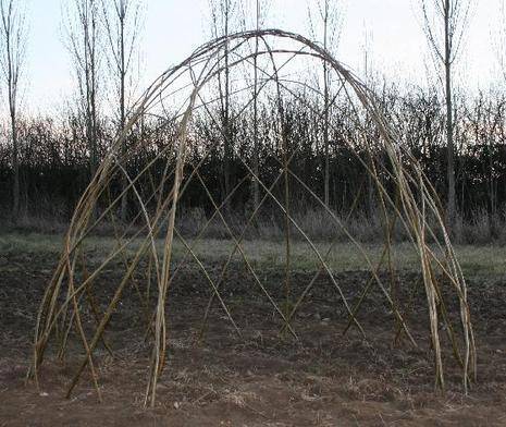 A hut type structure made from thin wooden sticks.