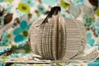 Pages from a book that have been cut and shaped to form a pumpkin.