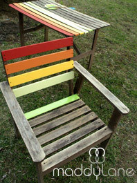 A wooden chair and table with their slats partially painted different colors.