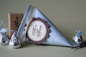 Violet color cone shape gift box with chocolates.